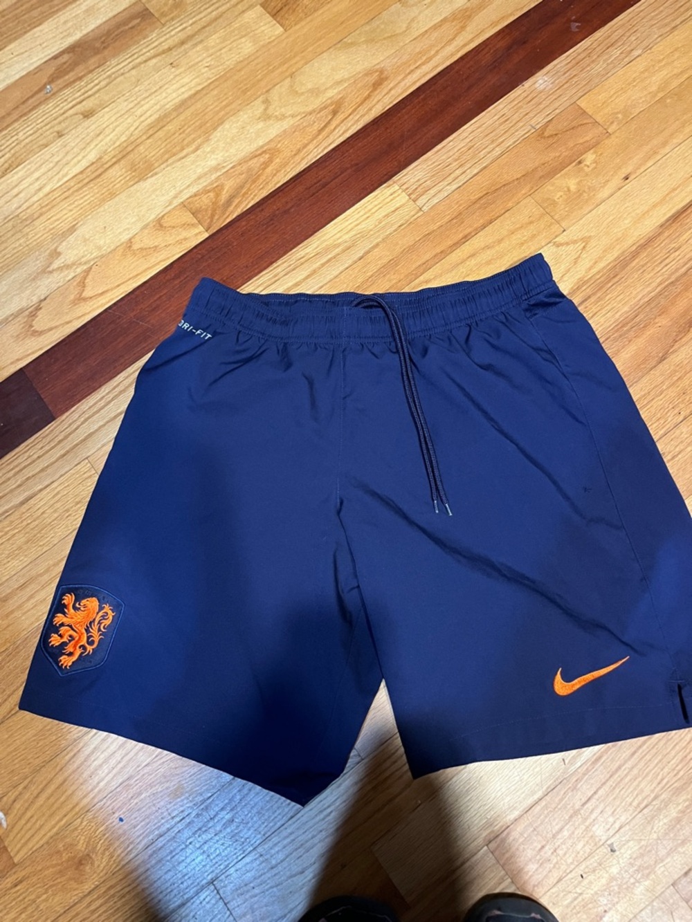 Nike Men’s Navy Athletic Shorts with Orange Nike Swoosh and Crest soccer th